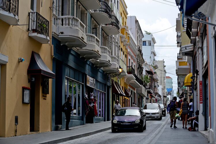 Pedestrians walk along Calle Fortaleza in Old San Juan, Puerto Rico, on Aug. 14.
