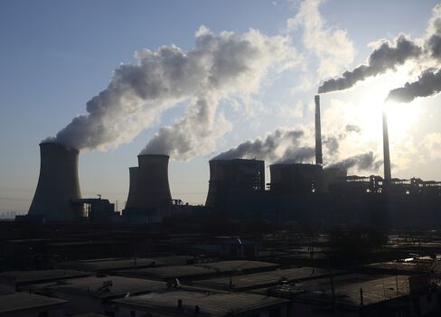 Steam rises from cooling towers at the Junliangcheng power station in Tianjin, China. In his agreement last week with President Barack Obama, Chinese President Xi Jinping committed to cap carbon emissions by 2030 and turn to renewable sources for 20 percent of the country’s energy. Photographer: Tomohiro Ohsumi/Bloomberg