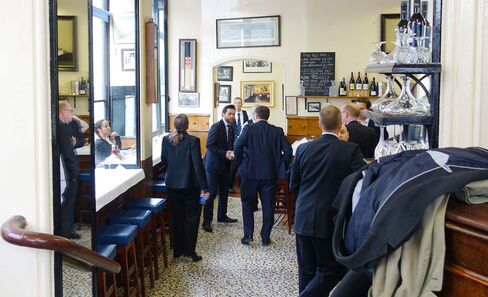 Guests wait at the bar.