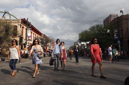 Pedestrians walk around Sixth street in Austin, Texas.
