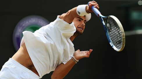 Rubin serves during the boys’ singles final match vs. Stefan Kozlov at Wimbledon on July 6, 2014.