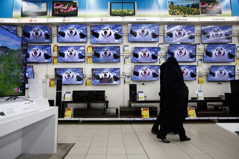 Customers browse flat screen televisions at an electronics store at the Hyperstar supermarket inside the Isfahan City Center shopping mall.