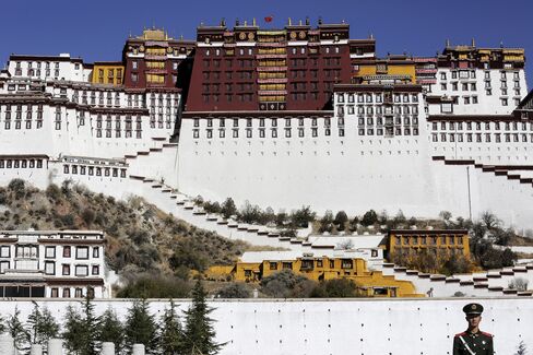 A paramilitary policeman stands guard in front of the Potala Palace.