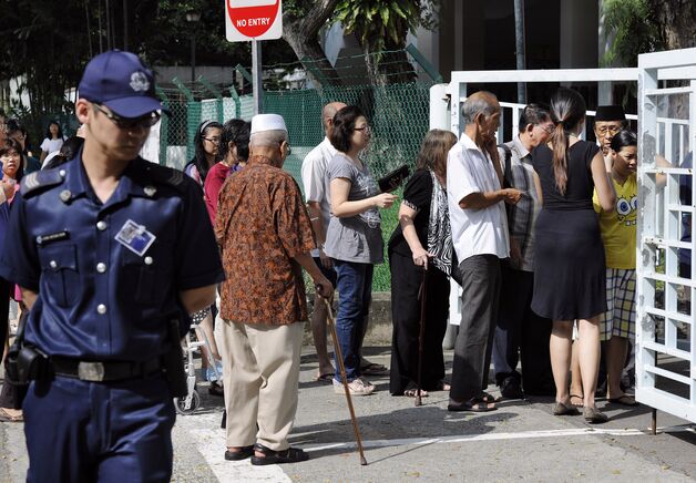 Voters queuing up outside a polling station.