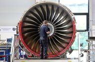 An employee works on a Trent 700 aircraft engine on the production line at the Rolls-Royce Holdings Plc factory in Derby, U.K., on Wednesday, Aug. 19, 2015. Rolls-Royce's XWB engine developed for the Airbus A350 should bring in twice the cash flow than the existing Trent 700 model on the Airbus A330, Chief Executive Warren East said in July. Photographer: Chris Ratcliffe/Bloomberg