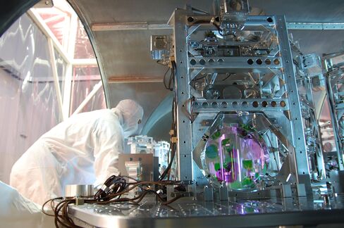 A technician works on one of LIGO's optics.