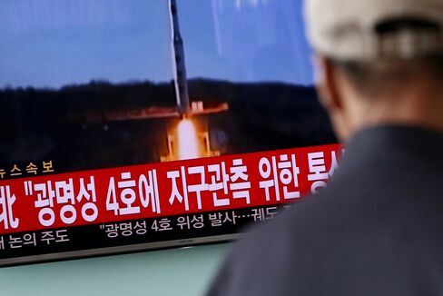 People watch a television screen showing a news broadcast on North Korea's long-range rocket launch at Seoul Station in Seoul, South Korea, on Sunday, Feb. 7, 2016. North Korea launched a long-range rocket Sunday, just weeks after conducting a fourth nuclear test in the latest setback for international efforts to pressure the Kim Jong Un regime to end its weapons program. Photographer: SeongJoon Cho/Bloomberg