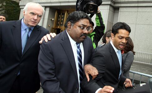 FILE PHOTO: Raj Rajaratnam, co-founder of Galleon Group LLC, center, exits federal court with his attorney Terence Lynam, left, in New York, U.S., on Thursday, Oct. 13, 2011. Rajaratnam, convicted of directing the biggest insider-trading ring in a generation, must go to prison while he challenges the government's use of wiretaps in his trial, an appeals court ruled. Rajaratnam is scheduled to begin an 11-year sentence at Federal Medical Center Devens in Ayer, Massachusetts, on Dec. 5. Photographer: Rick Maiman/Bloomberg *** Local Caption *** Raj Rajaratnam; Terence Lynam