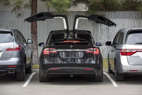 tesla motors inc doors suv surprises drive parked gullwing open customers starting options bloomberg driving gets