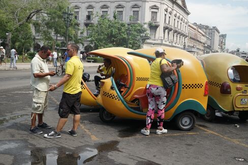 Havana's Coco Taxis, named for their coconut shape. Drivers rent their vehicles from a state company.