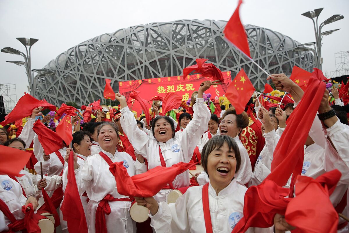People celebrate in front of the National Stadium after Beijing was awarded host city for the 2022 Winter Olympics, in Beijing, on July 31, 2015. Photographer: ChinaFotoPress/ChinaFotoPress via Getty Images