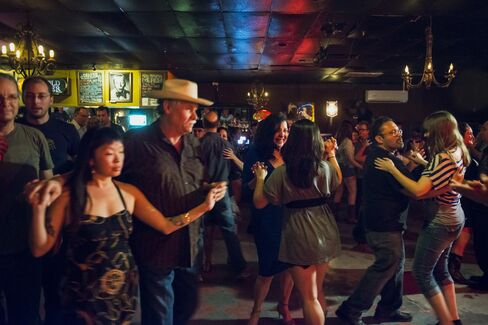 Patrons dance at The White Horse bar.