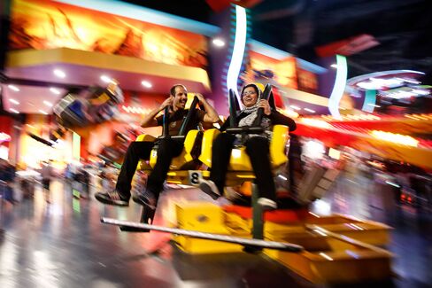 A couple enjoy a ride in the amusement park inside the Isfahan City Center shopping mall.