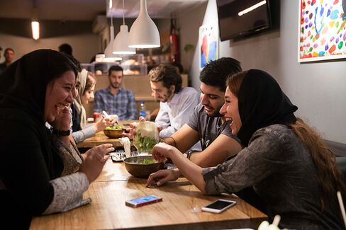 Young couples enjoy a meal in a western style restaurant in Tehran.