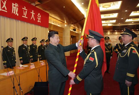 Xi Jinping confers military flags on the five newly-established theater commands of the PLA.