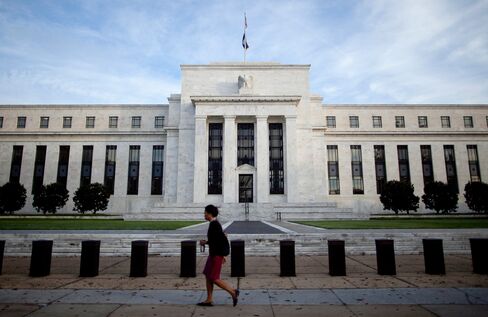 A woman walks past the Marriner S. Eccles Federal Reserve Board Building in Washington D.C