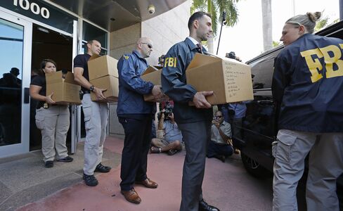 FBI agents carry boxes from the headquarters of CONCACAF in Miami Beach, on May 27, 2015.
