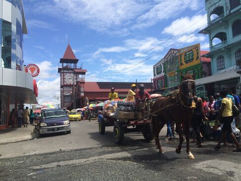 Vendors head to the market in Georgetown, Guyana. Photographer: Andrew Rosati