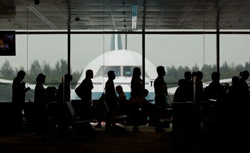 Passengers board a Cathay Pacific Boeing 747 airplane at Changi Airport in Singapore.
