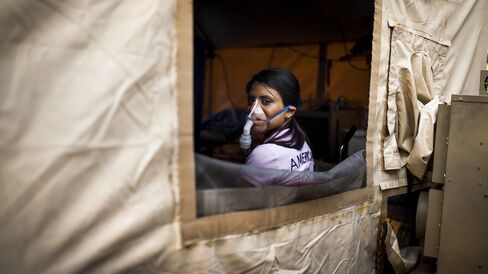 A woman receives respiratory treatment in Caracas, on March 23, 2016.