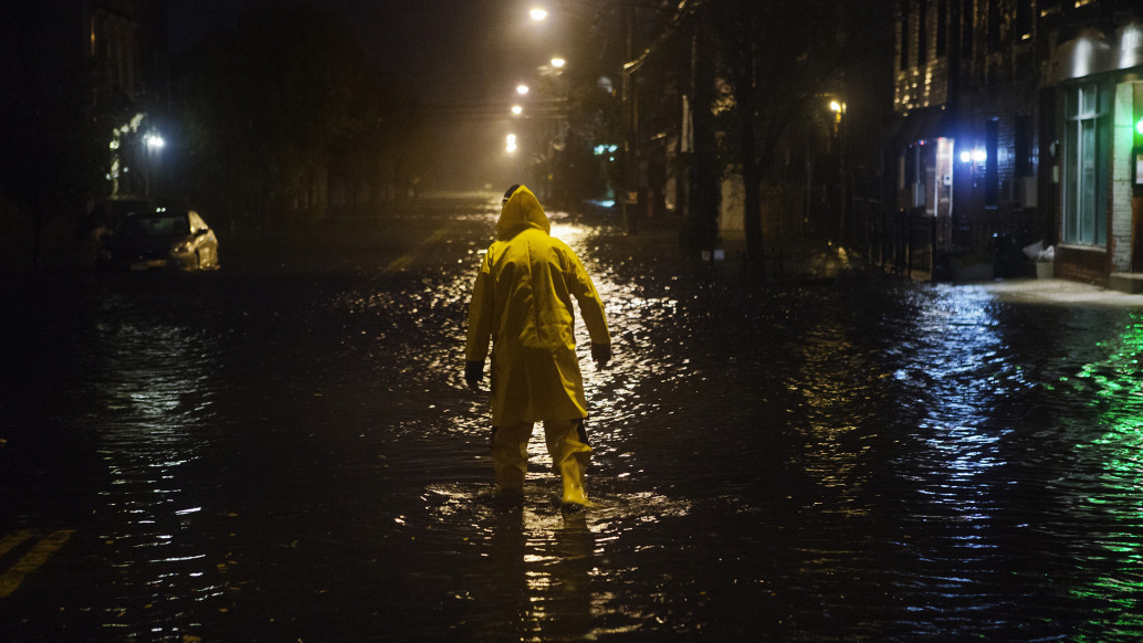 A resident wades through a flooded street in Red Hook during Hurricane Sandy. 
