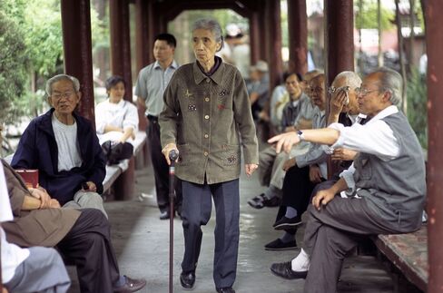 Group of people chatting and walking under a covered walkway at a Buddhist temple compound - Wenshu Temple - Chengdu - Sichuan Province, China