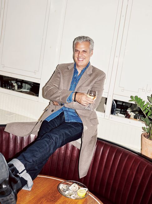 Ripert relaxes at the Standard Grill in New York’s Meatpacking District. Wool-and-cashmere cloth overcoat and denim slim-fit shirt by Brunello Cucinelli, $4,595 and $525; brunellocucinelli.com. Matchbox in Alpha jeans by AG, $198; agjeans.com. Tortoise heritage keyhole sunglasses by Ralph Lauren, $279; ralphlauren.com. Black calfskin Chelsea boots by Ralph Lauren, $750; ralphlauren.com