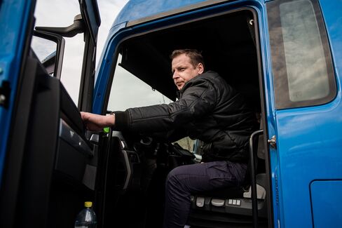 Zoltan Unczorg, a Hungarian truck driver, closes his truck door in the customs zone near the Austrian-German border.