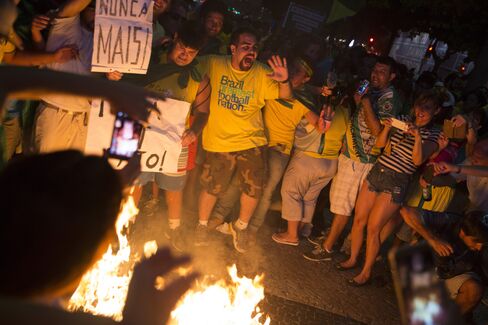 Protesters burn a figure in Rousseff’s likeness.