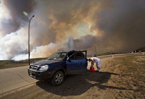 An evacuee puts gas in his car on his way out of Fort McMurray on May 4.