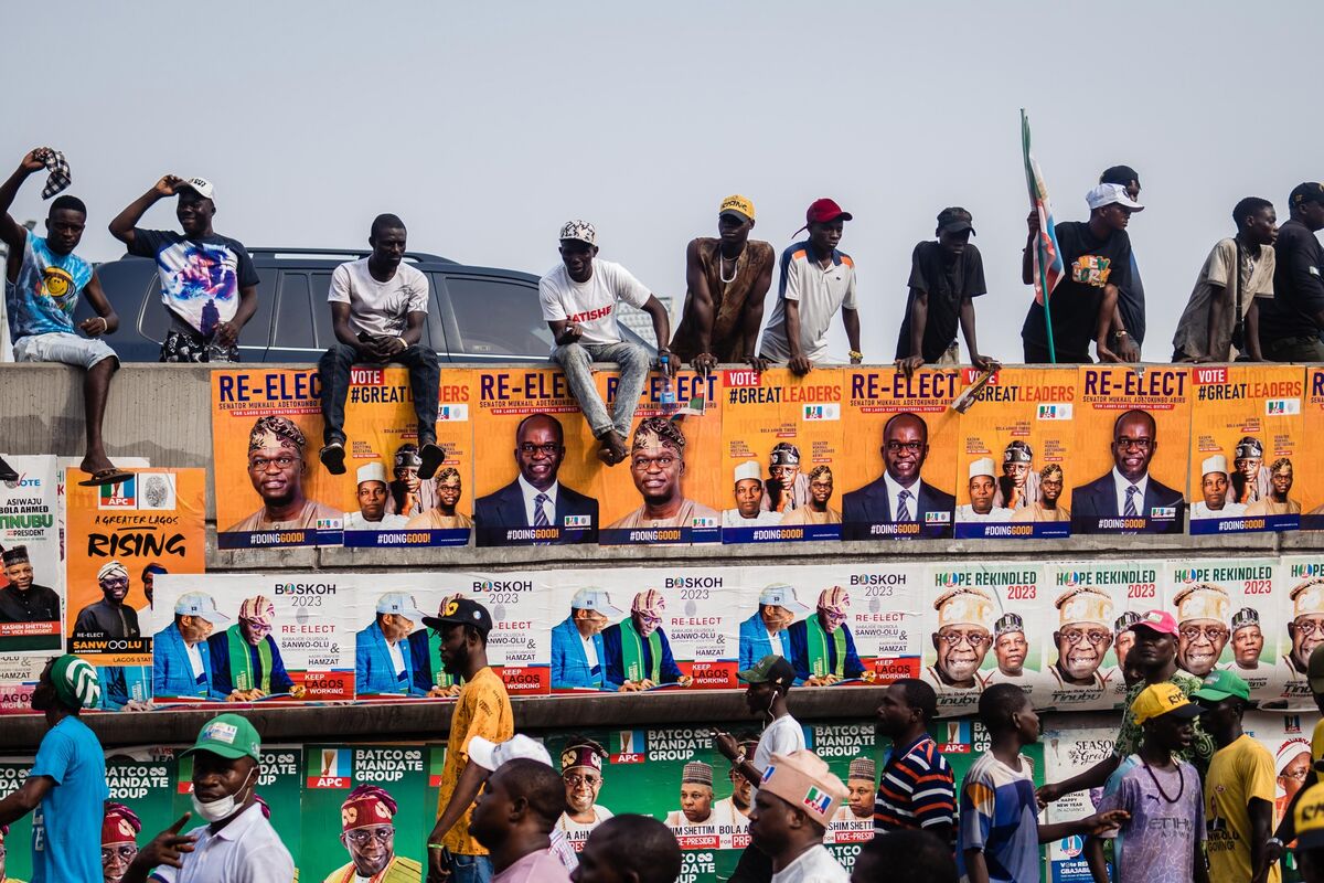 Supporters on a wall during a campaign rally for Nigeria presidential candidate Bola Tinubu.