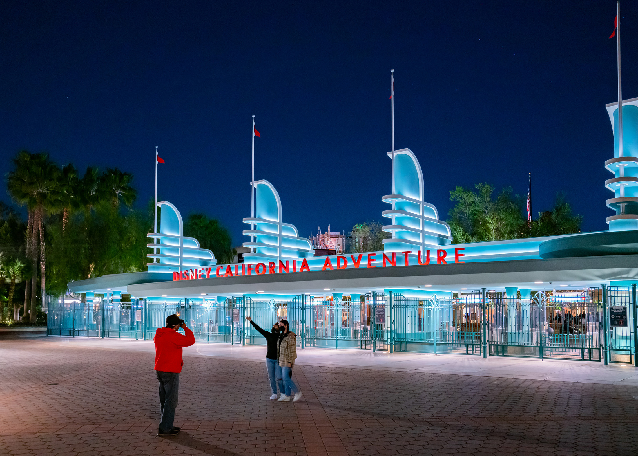 Visitors take a photo outside the Disney California Adventure park at the Disneyland Tourist Information Center in Anaheim California, on Feb. 18.