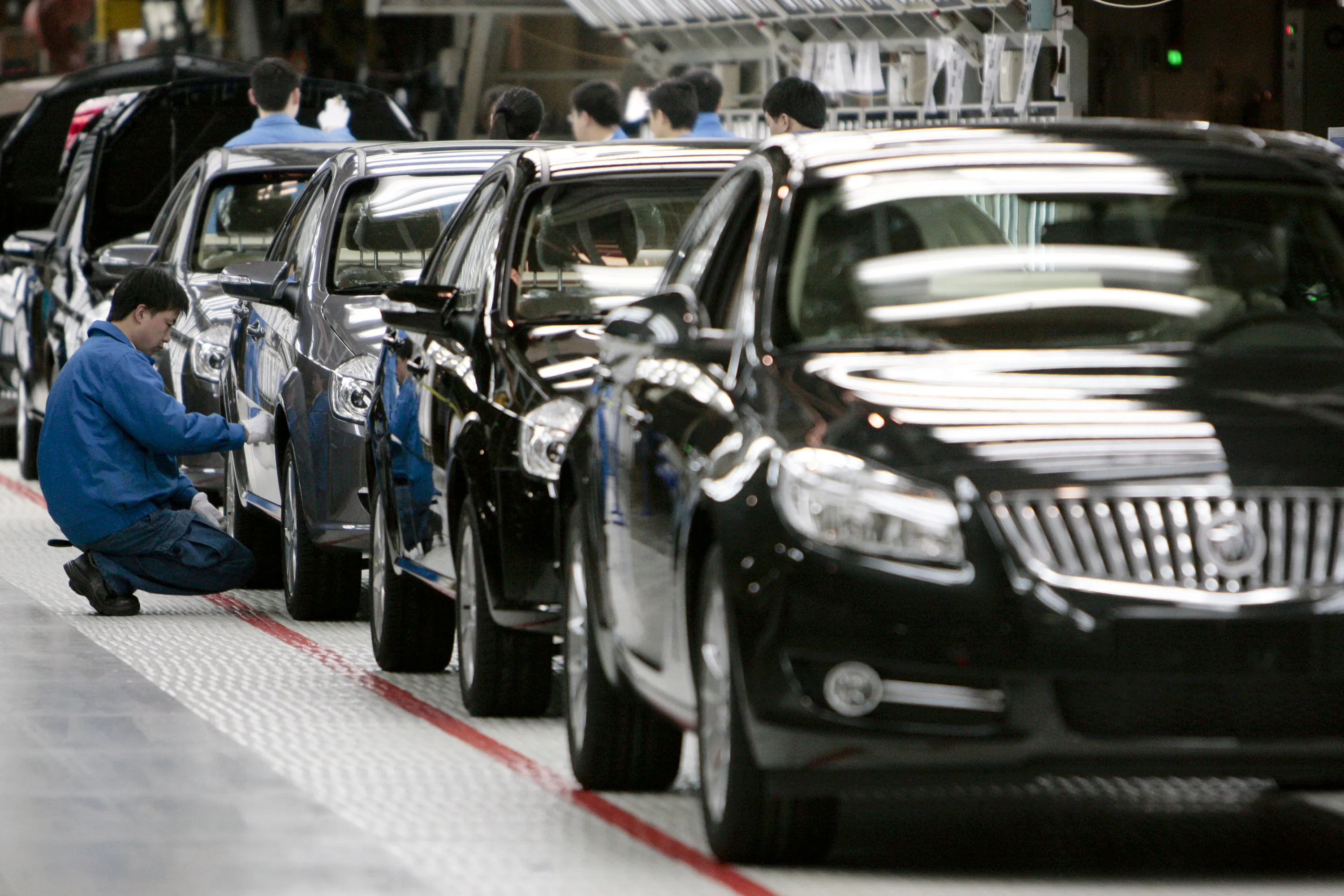 A worker inspects a General Motors Co. vehicle on the assembly line at a Shanghai GM plant in Shanghai China&nbsp;