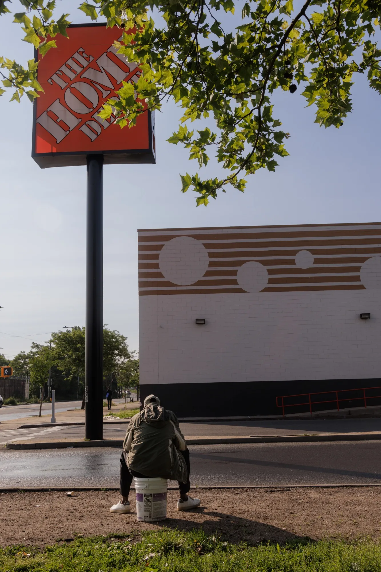 A day laborer waits for job offers near a Home Depot in the Bronx.