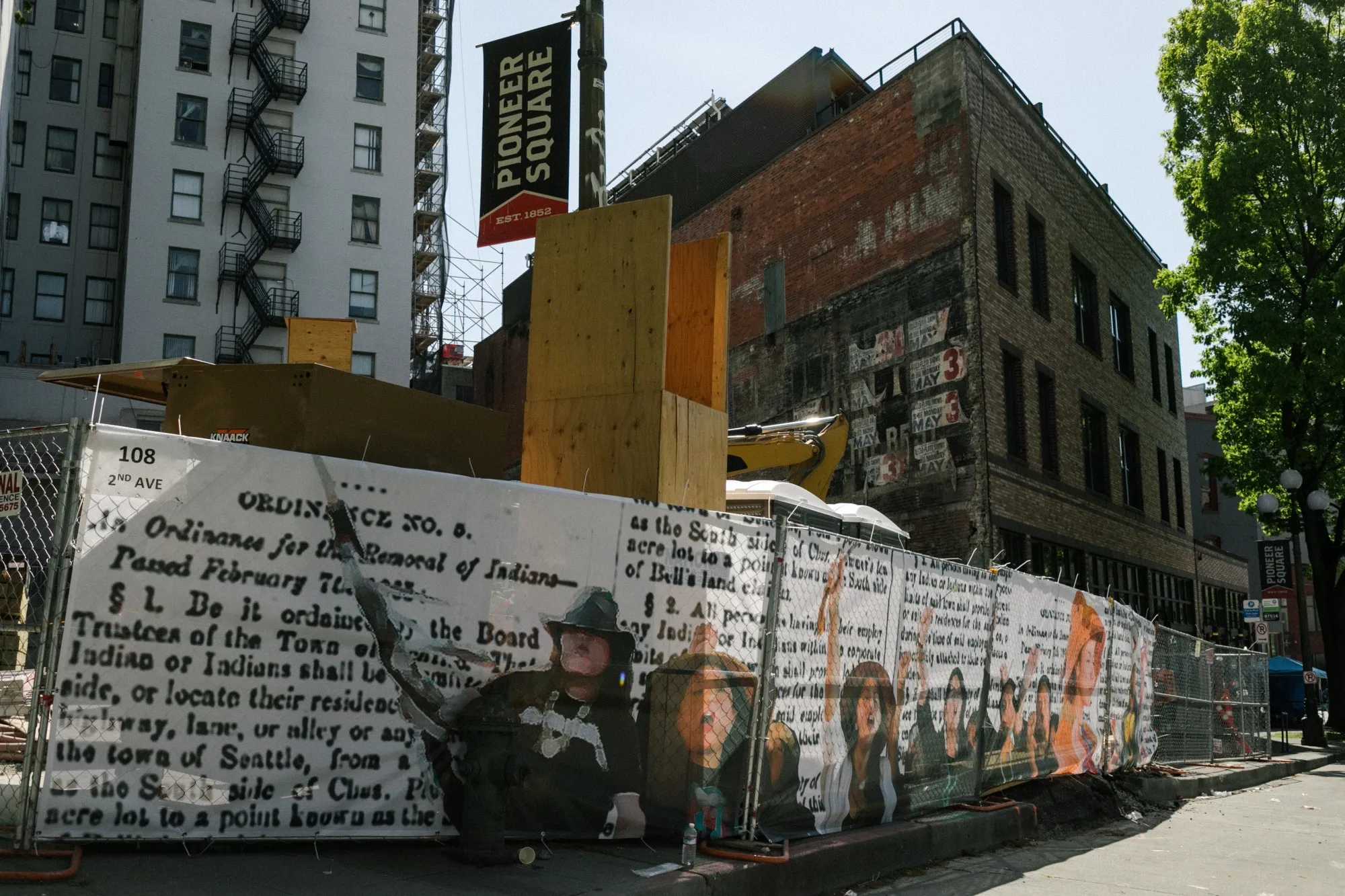 The fencing around a&nbsp;new Seattle housing project aimed at Native Americans is decorated with images from the 1865 city ordinance that expelled Indigenous people from the city.&nbsp;