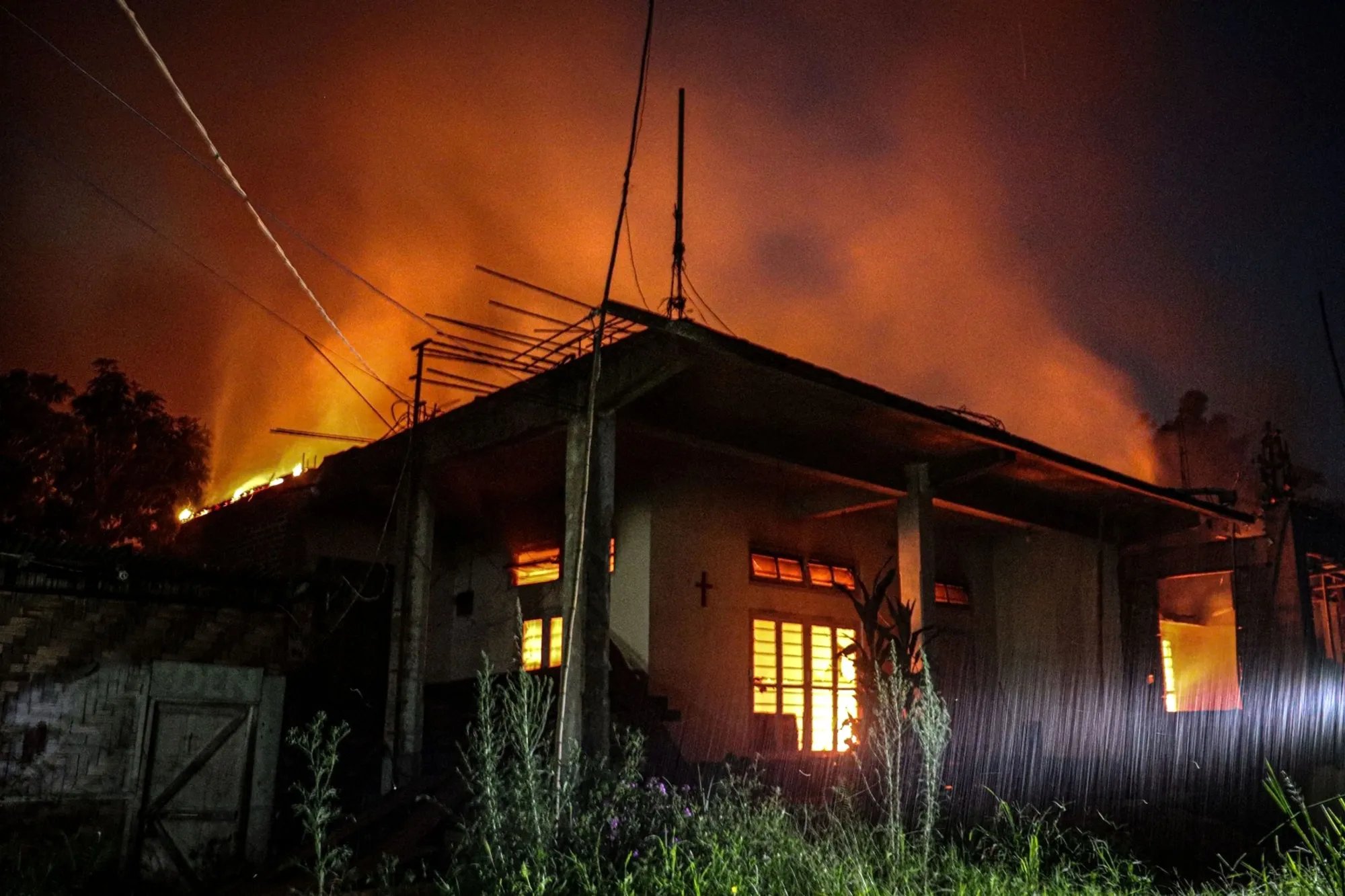Smoke billows from an abandoned house set on fire in Manipur on Aug. 5.