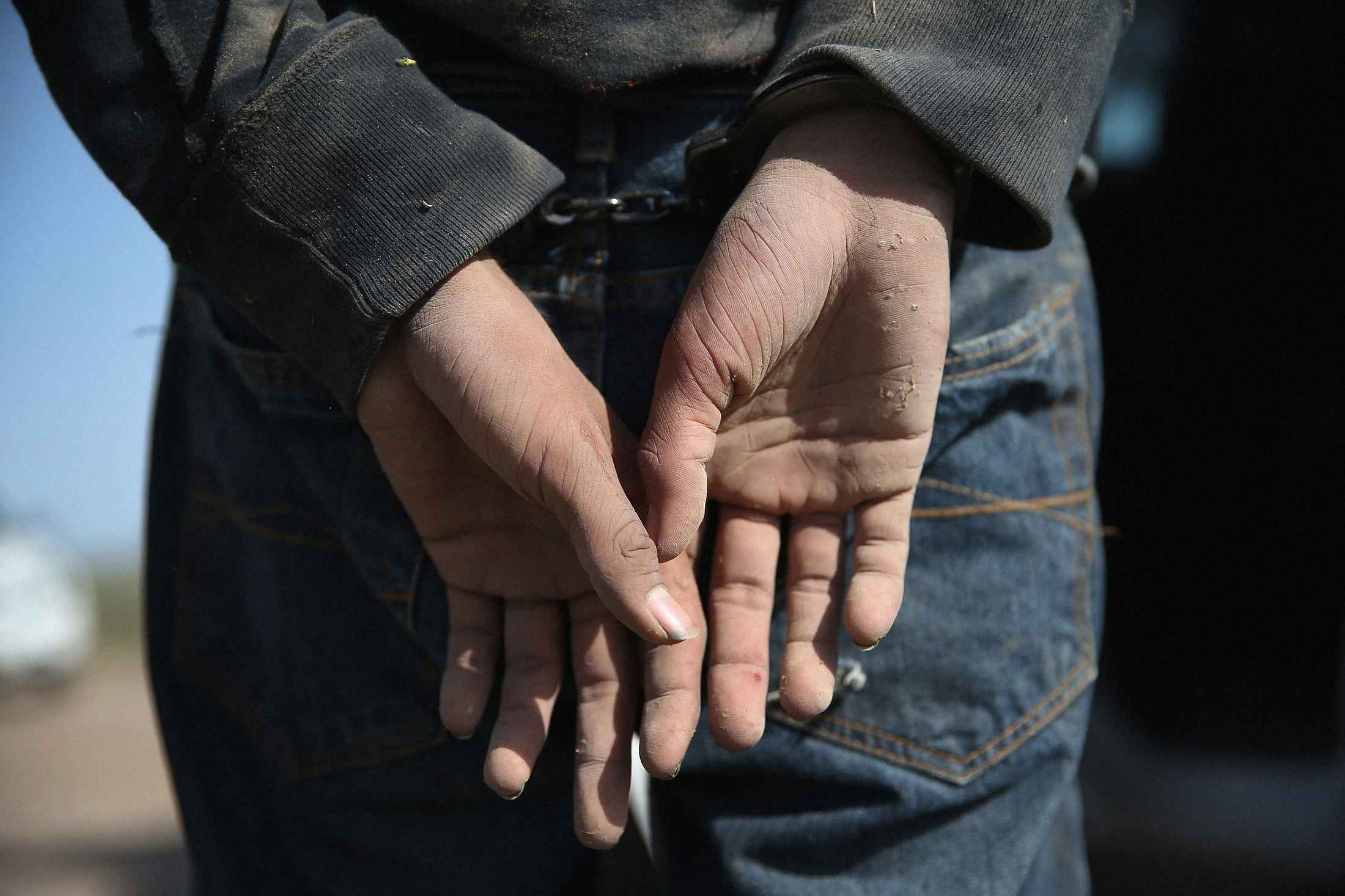 An undocumented immigrant is detained by the U.S. Border Patrol near the U.S.-Mexico border.
