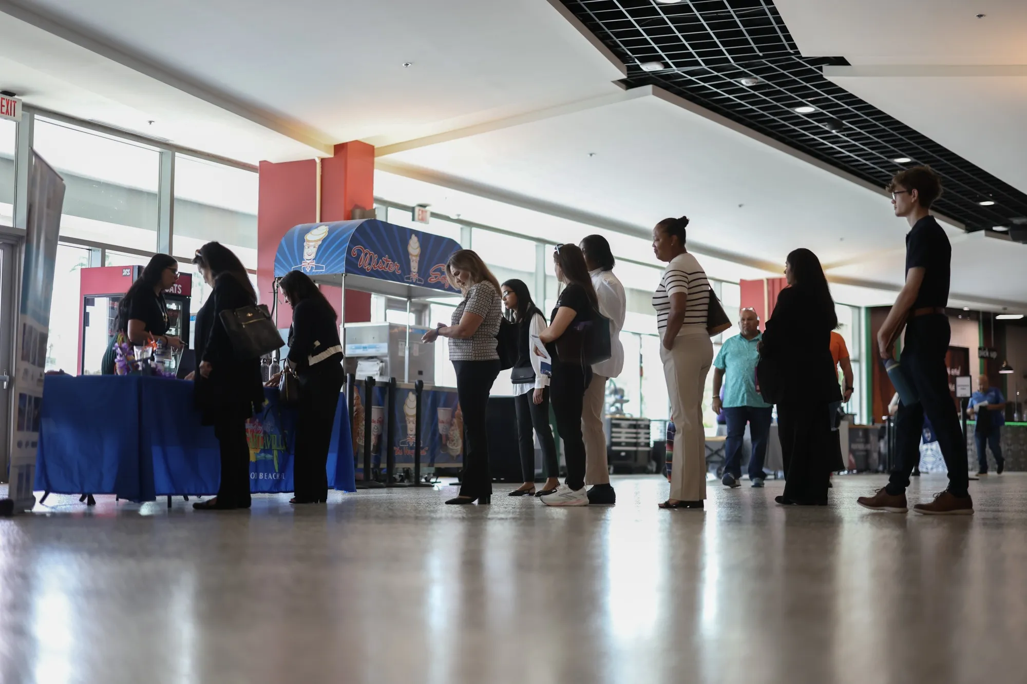 Job seekers wait to speak with a recruiter at a south Florida job fair in September.