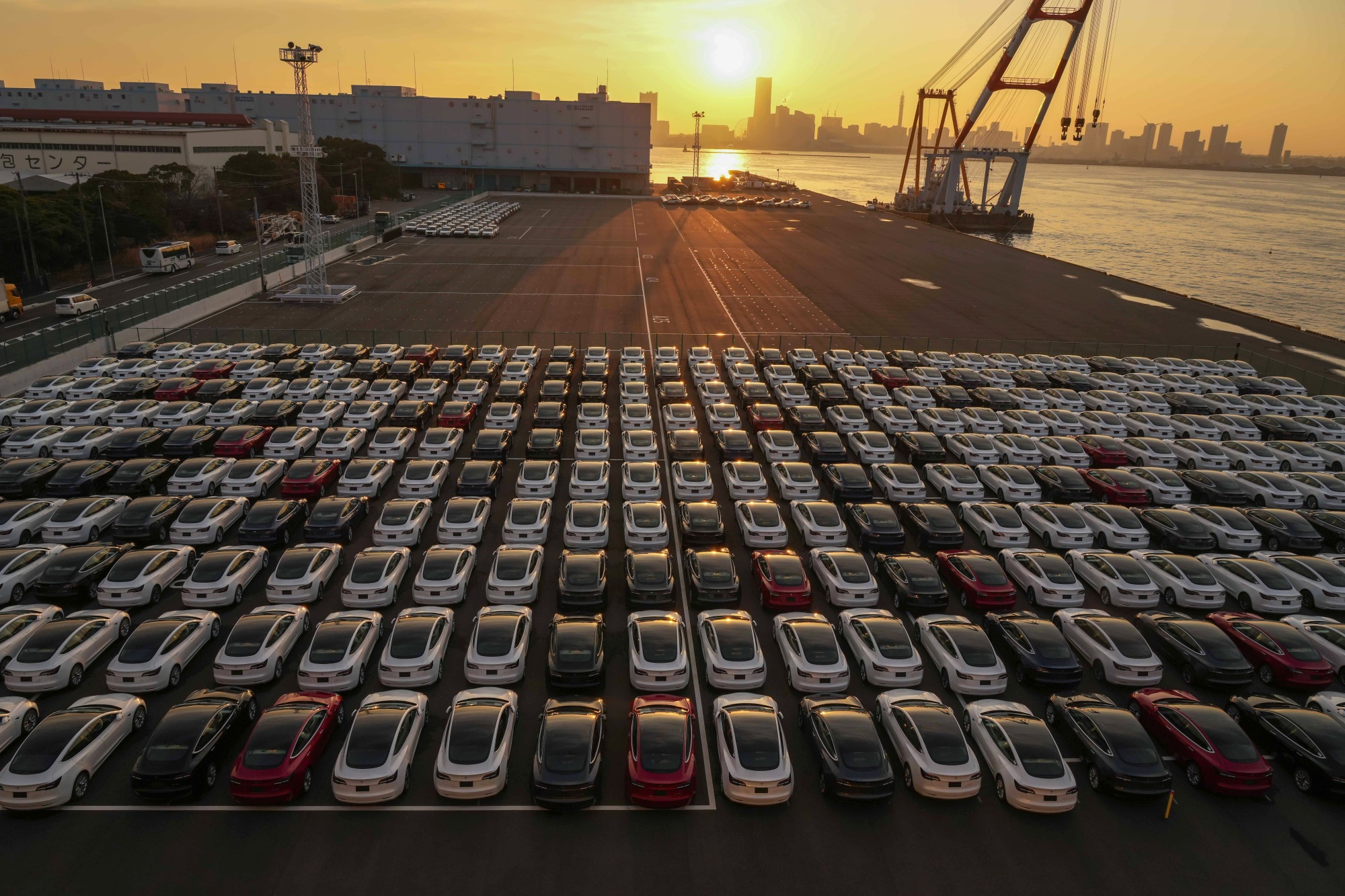 Tesla Inc. vehicles in a parking lot after arriving at a port in Yokohama, Japan, on Monday, Feb. 14, 2022. Japan is scheduled to release trade balance figures on Feb. 17.