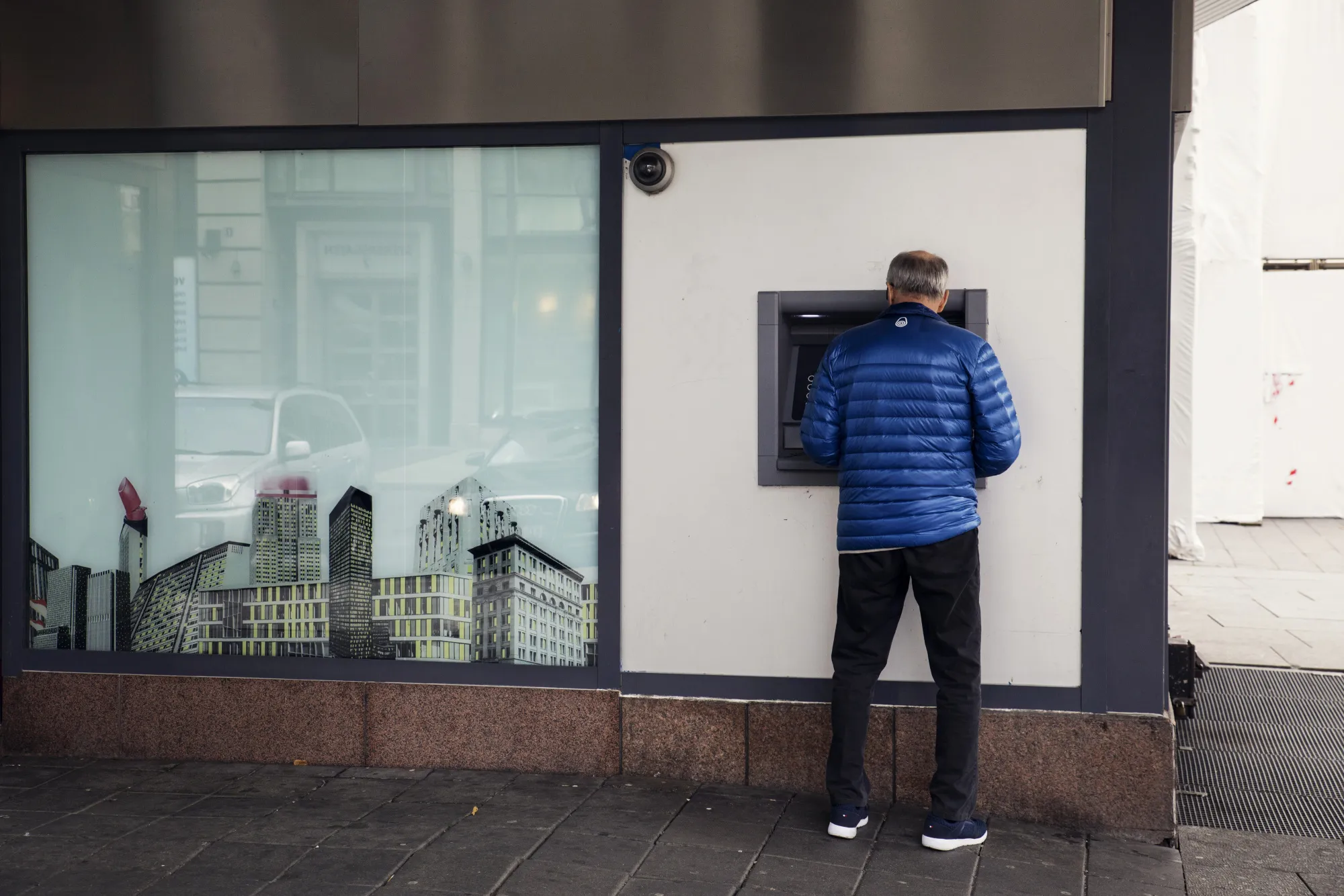 A customer uses an automated teller machine at a bank branch in Oslo.