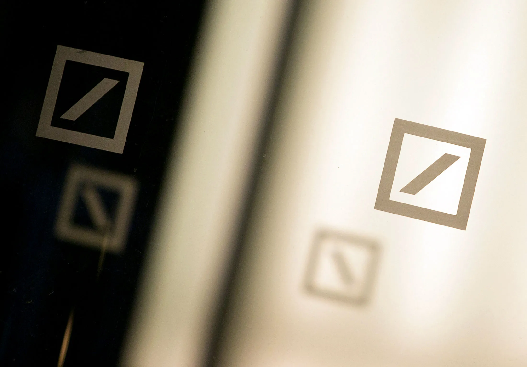 The logo of Deutsche Bank AG sits on windows of the bank's offices in Berlin, Germany, on Monday, Oct. 12, 2015. Deutsche Bank co-Chief Executive Officer John Cryan may eliminate a dividend that's stood since Germany's postwar reconstruction as he tries to overhaul the firm without asking shareholders for more capital.
