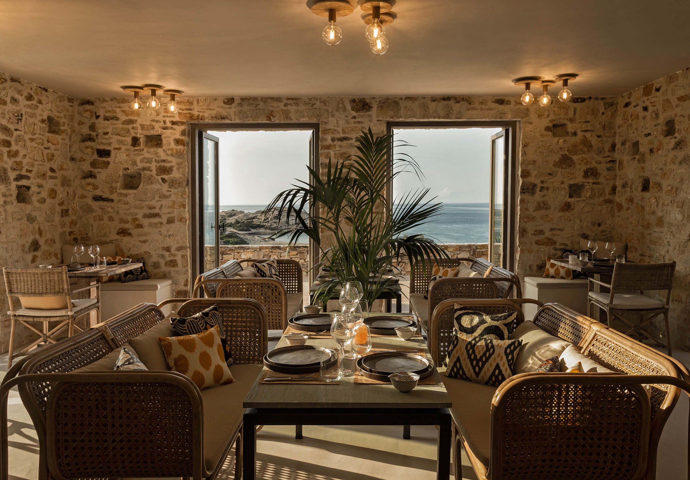 A rustic, stone-walled dining room at the Rooster Antiparos.