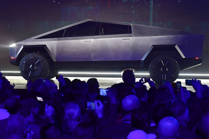 Image of a silver, futuristic Tesla Cybertruck