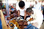 Health officials attend to children suffering malnutrition in a clinic set up by health authorities in collaboraion with Medecins Sans Frontieres or Doctors Without Borders (MSF)in Katsina State, northwest Nigeria, on July 20, 2022. - Rural northwest Nigeria has been ravaged by gangs of bandit militias who raid villages, loot cattle and kidnap people to hold them for ransom in camps deep in the forests that carpet large swaths of the region. Hundreds of thousands have been displaced across the northwest and central regions, and thousands killed in violence rivalling the impact of the 13-year jihadist conflict that has killed more than 40,000 people. (Photo by PIUS UTOMI EKPEI / AFP) (Photo by PIUS UTOMI EKPEI/AFP via Getty Images)