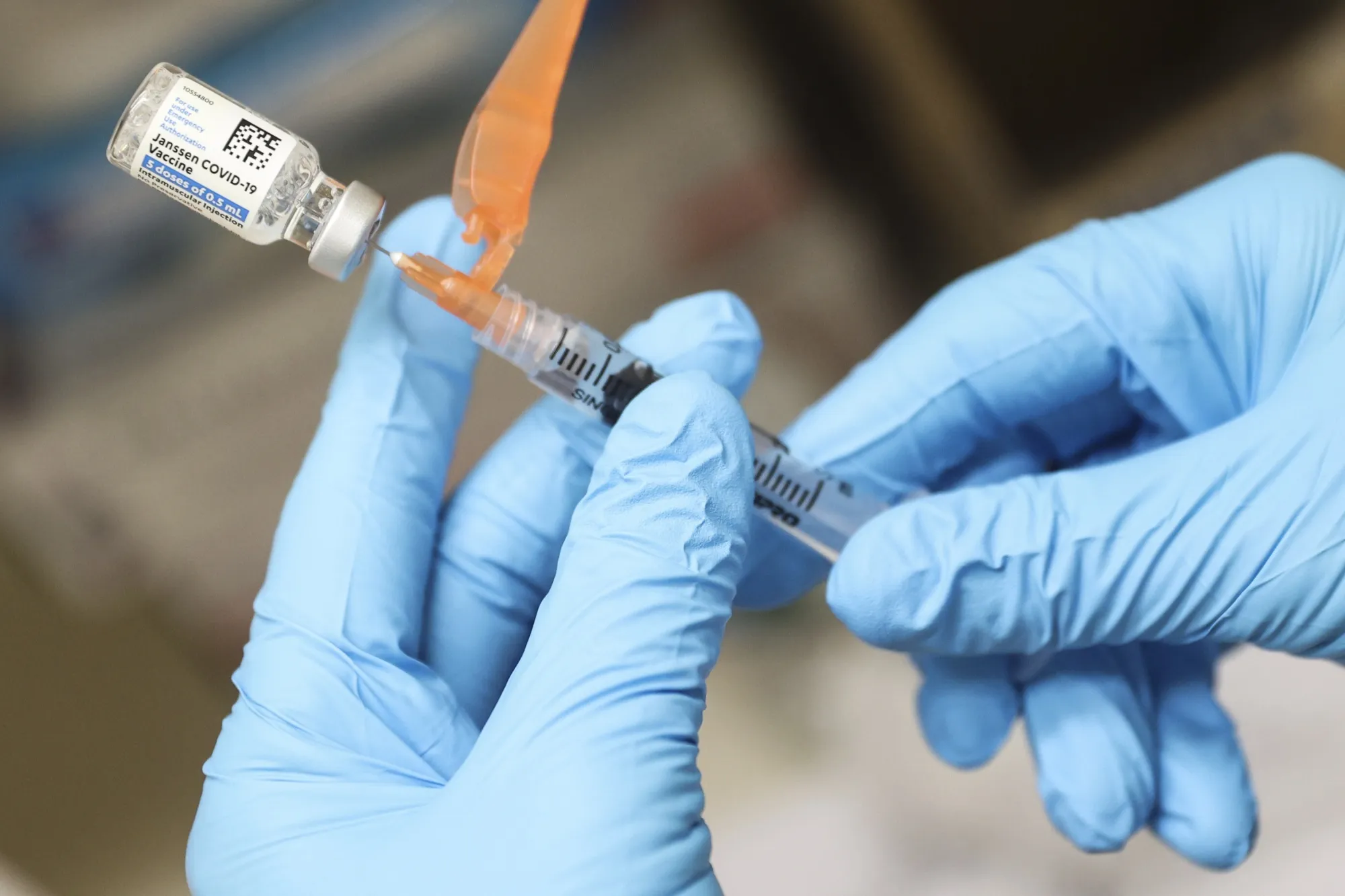 A healthcare worker prepares a dose of Covid-19 vaccine.