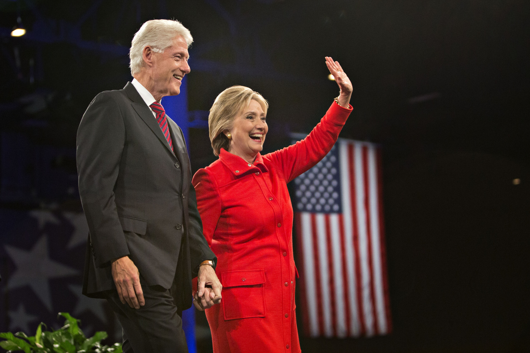 Hillary Clinton stands on stage with husband Bill Clinton at the conclusion of the Jefferson-Jackson Dinner in Des Moines, Iowa, on Oct. 24, 2015.

