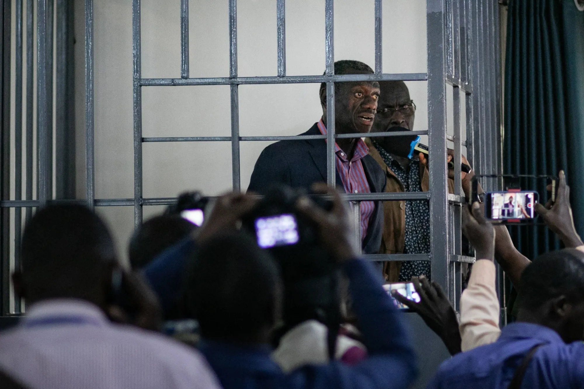 Kizza Besigye addresses the media from the dock at the Makindye Martial Court in Kampala, on Nov. 20.