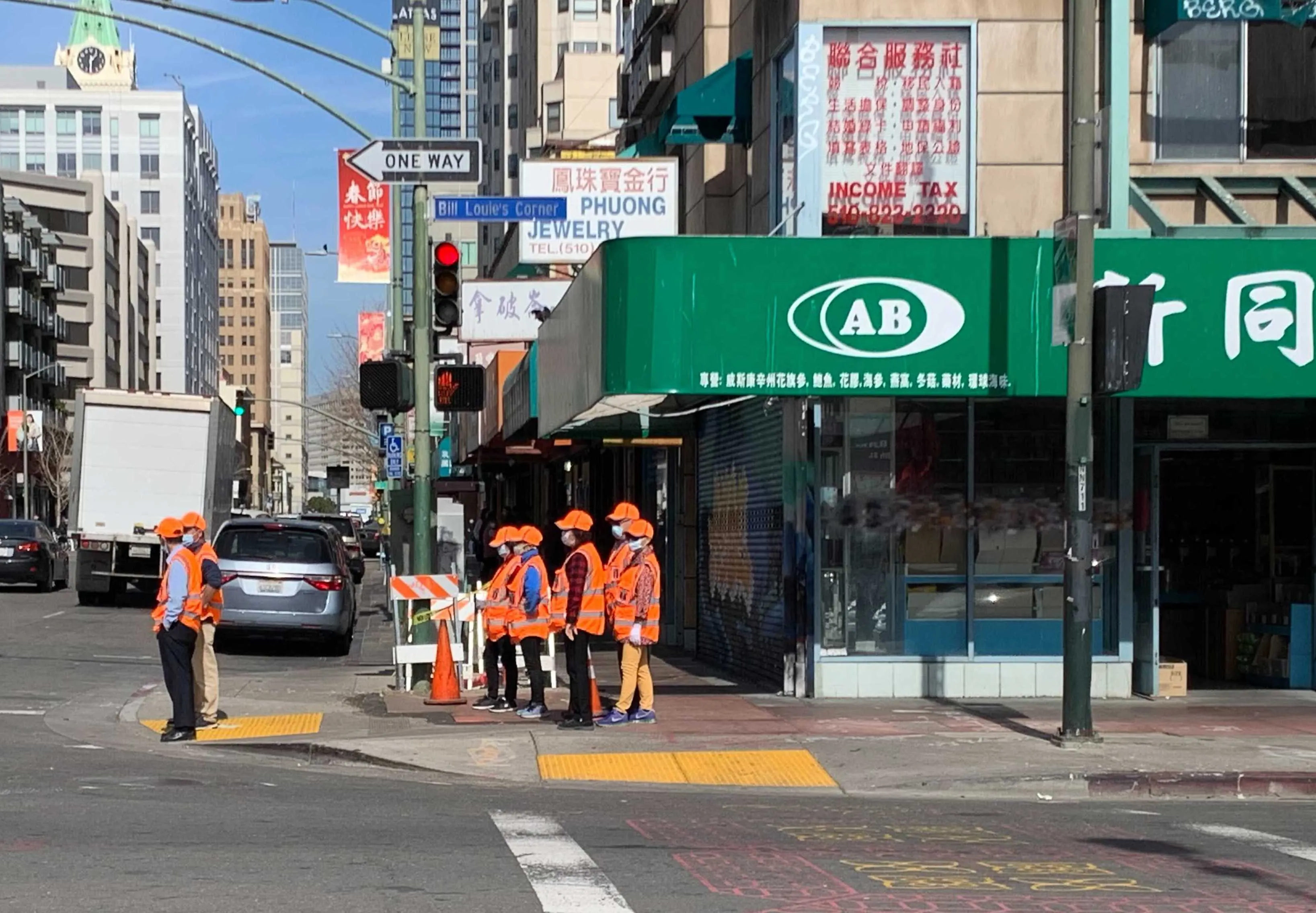 A foot patrol led by the East Bay Toishan Association walks the streets of Oakland’s Chinatown.