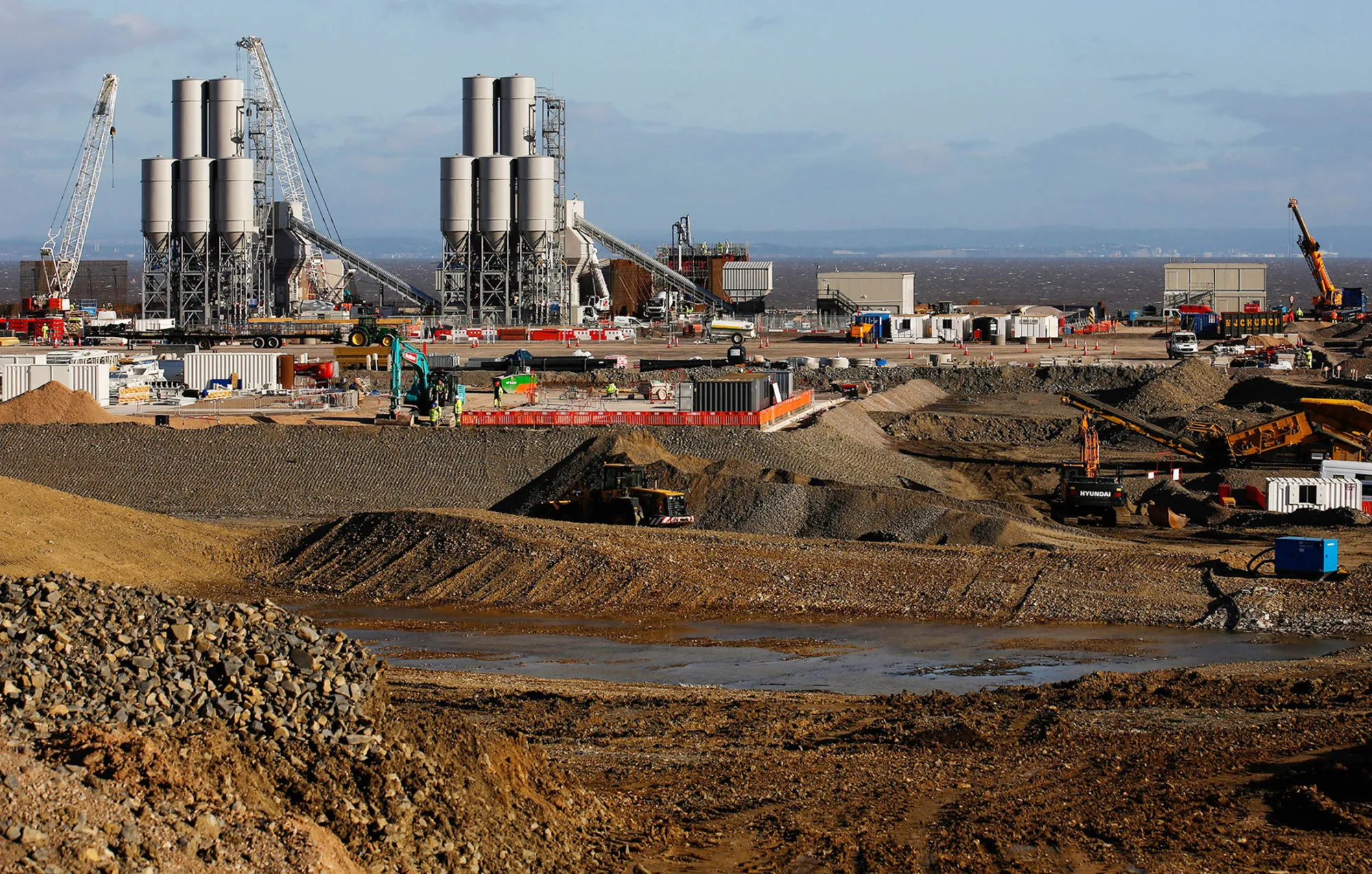 The concrete batching plant stands on the horizon as work recommences at the Hinkley Point C nuclear power station, operated by Electricite de France SA's (EDF), near Bridgwater, U.K., on Sept. 16, 2016.
