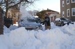 A resident shovels snow around a vehicle after a blizzard in Boston, Massachusetts, on Jan. 30.